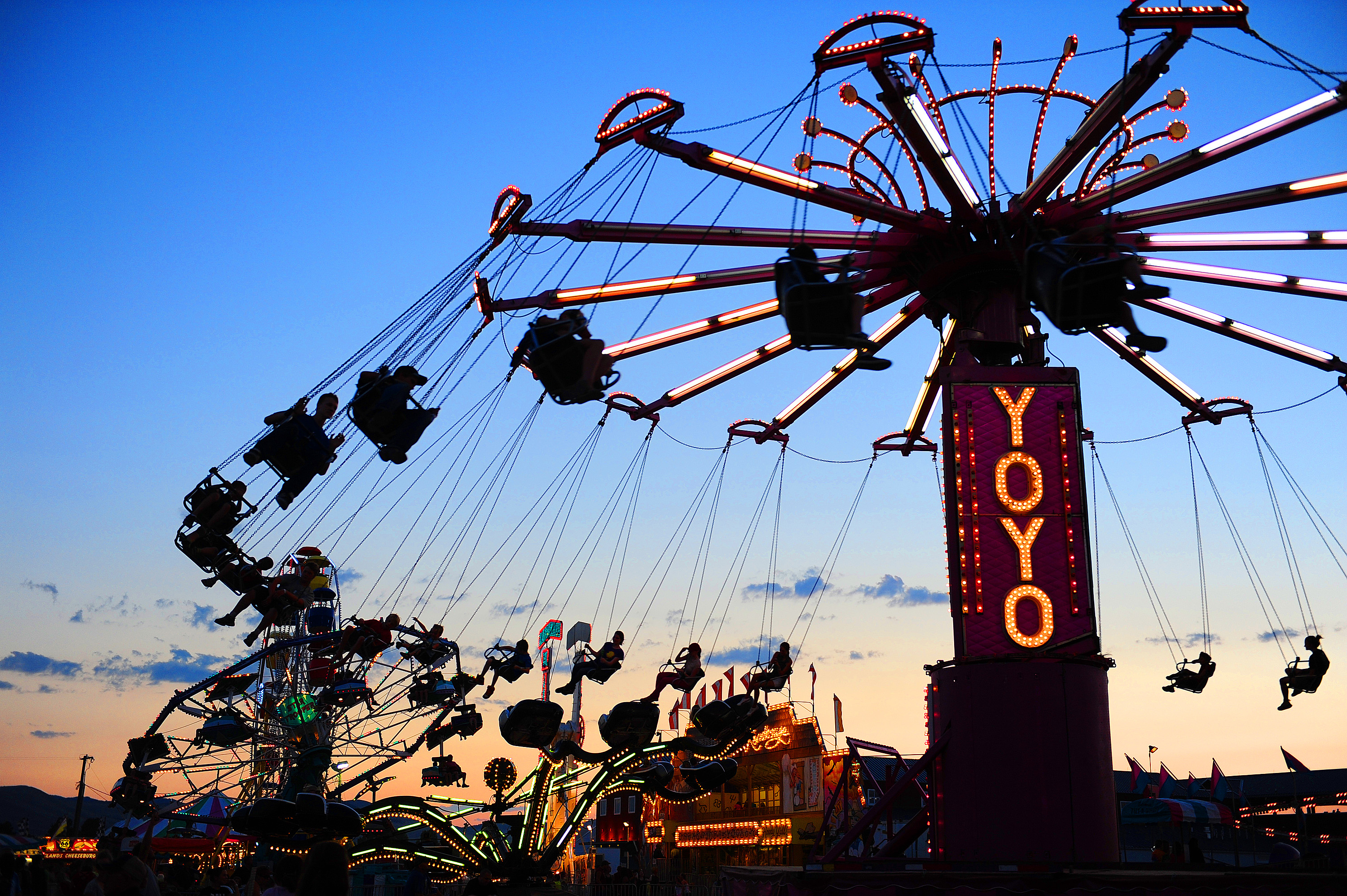 Fairground swing ride glowing at dusk